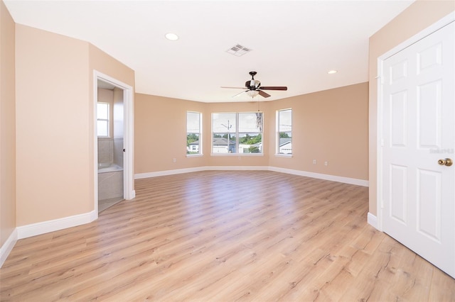 empty room with ceiling fan and light wood-type flooring