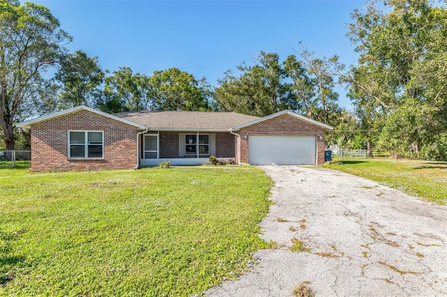 single story home featuring a front lawn and a garage