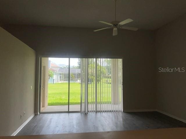 spare room featuring dark hardwood / wood-style floors and ceiling fan