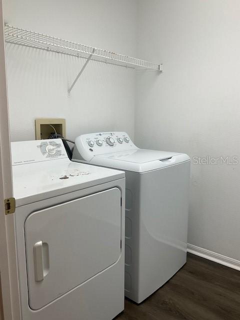 washroom featuring washer and dryer and dark hardwood / wood-style floors