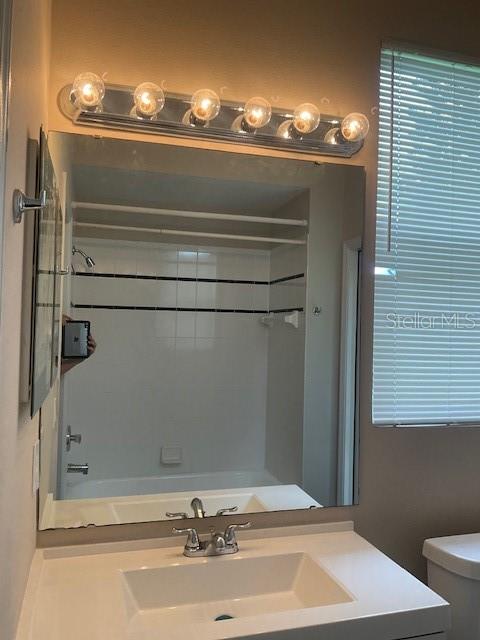 full bathroom with vanity,  shower combination, and toilet