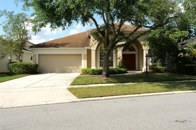 view of front of property with driveway, stucco siding, and an attached garage