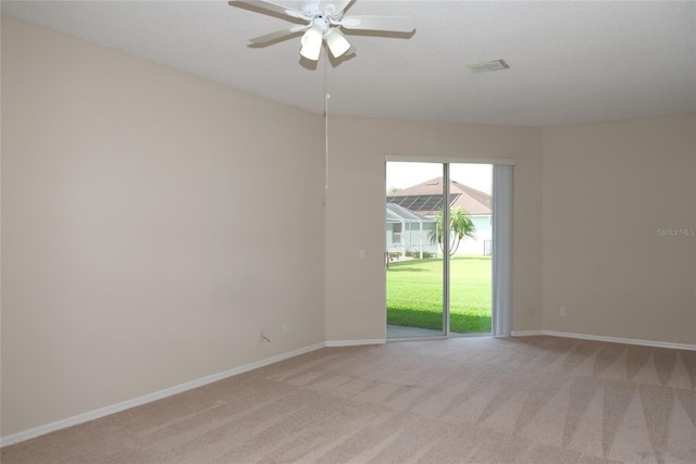 unfurnished room featuring visible vents, baseboards, and light carpet