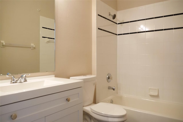 bathroom featuring washtub / shower combination, vanity, and toilet