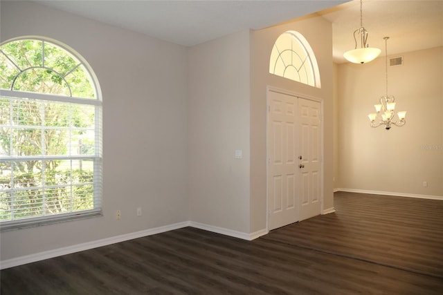 519 Lakescape Ct, Orlando, FL 32828 - unfurnished room with healthy amount of natural light, dark wood-style flooring, and a chandelier