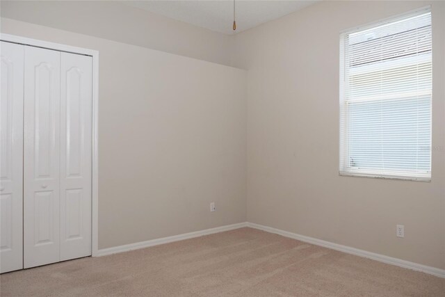 519 Lakescape Ct, Orlando, FL 32828 - unfurnished bedroom with light colored carpet and a closet