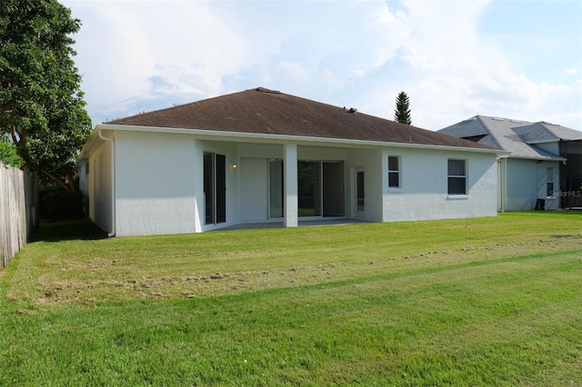 519 Lakescape Ct, Orlando, FL 32828 - back of house featuring stucco siding and a lawn