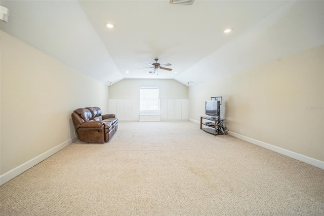 unfurnished room with light colored carpet and vaulted ceiling