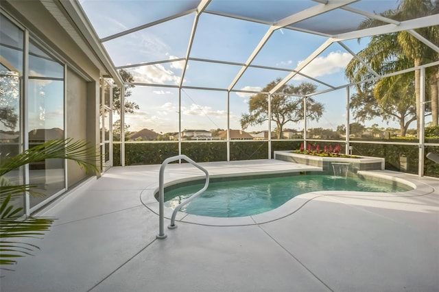 view of swimming pool with pool water feature, glass enclosure, and a patio