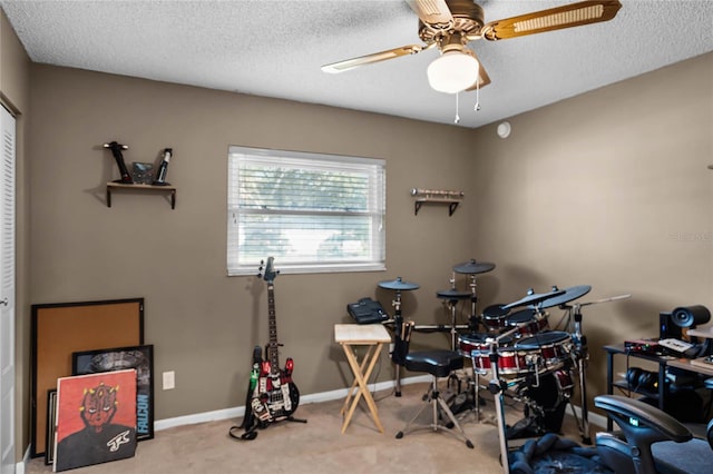 miscellaneous room with light carpet, a textured ceiling, and ceiling fan