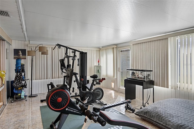 exercise area featuring a textured ceiling