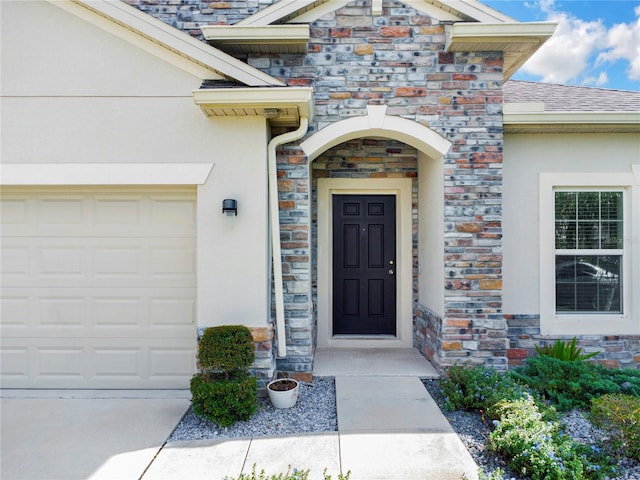 view of exterior entry featuring a garage