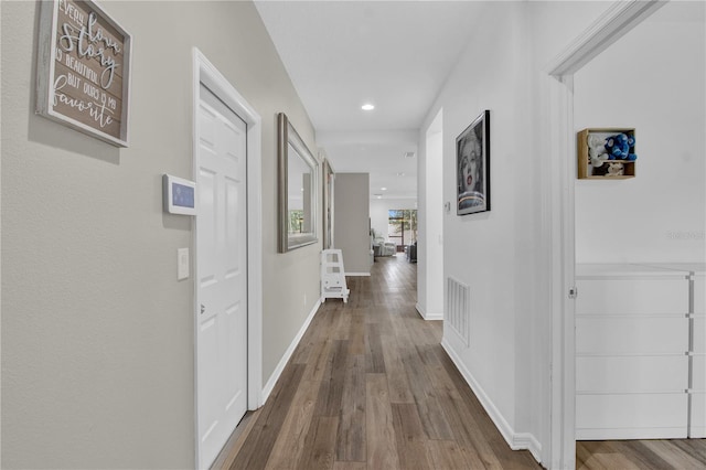 corridor with wood-type flooring