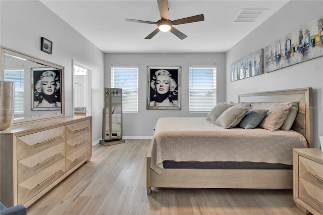 bedroom with light hardwood / wood-style floors and ceiling fan