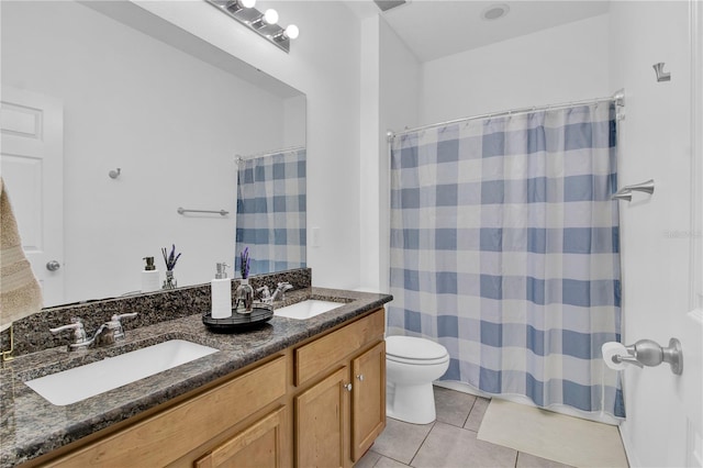 bathroom with toilet, vanity, tile patterned floors, and walk in shower