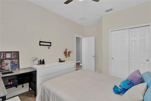 bedroom featuring ceiling fan, light wood-type flooring, and a closet