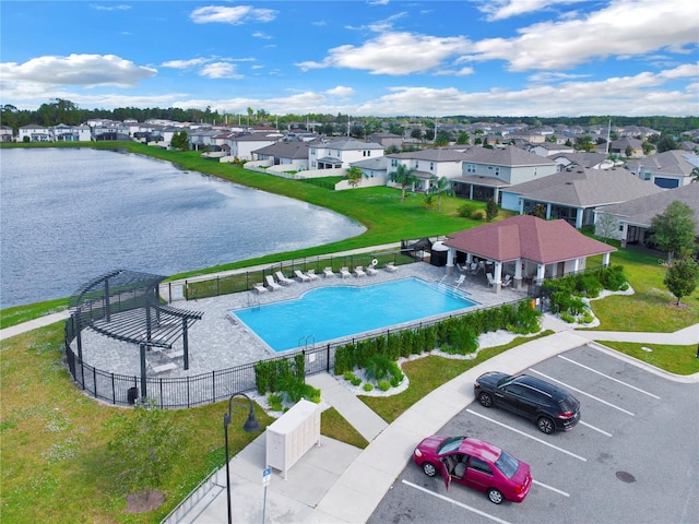 view of swimming pool featuring a water view