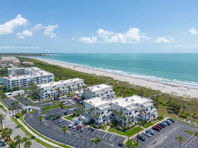 aerial view with a water view and a beach view