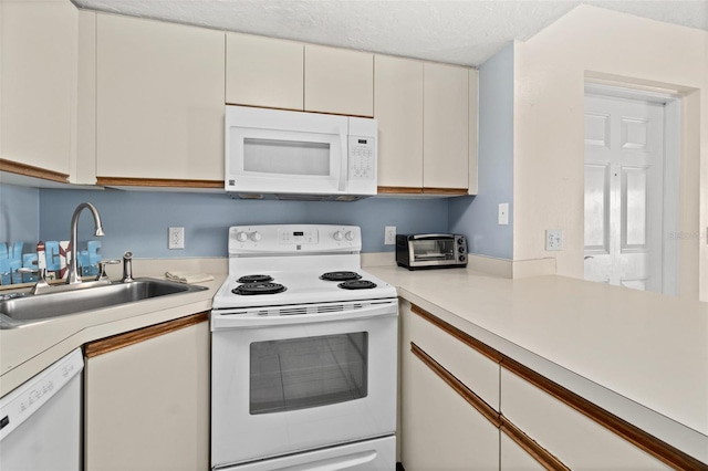 kitchen with a textured ceiling, sink, white cabinets, and white appliances