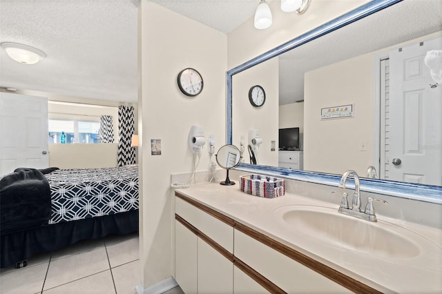 bathroom featuring tile patterned flooring, vanity, and a textured ceiling