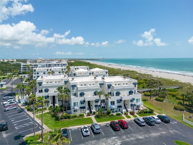 birds eye view of property with a water view and a view of the beach