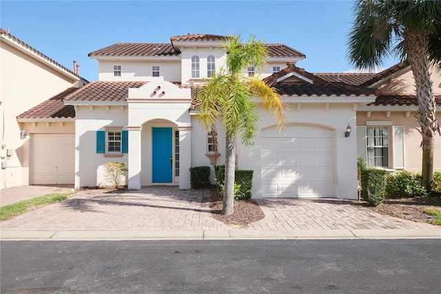 mediterranean / spanish house with a garage