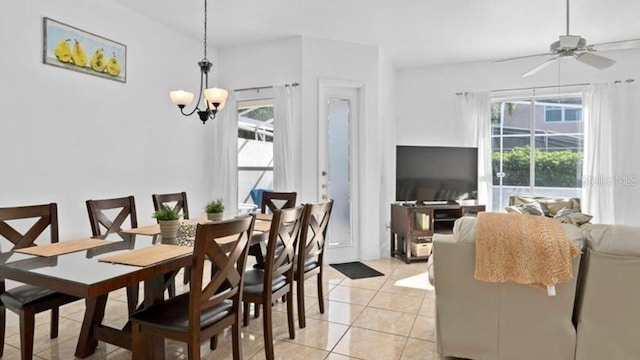 tiled dining room with ceiling fan with notable chandelier