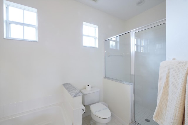 bathroom featuring toilet, tile patterned floors, and independent shower and bath