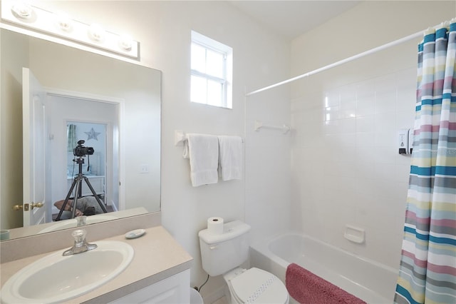 full bathroom featuring toilet, vanity, and shower / tub combo with curtain