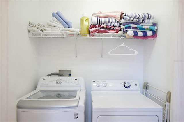 laundry room featuring washing machine and clothes dryer