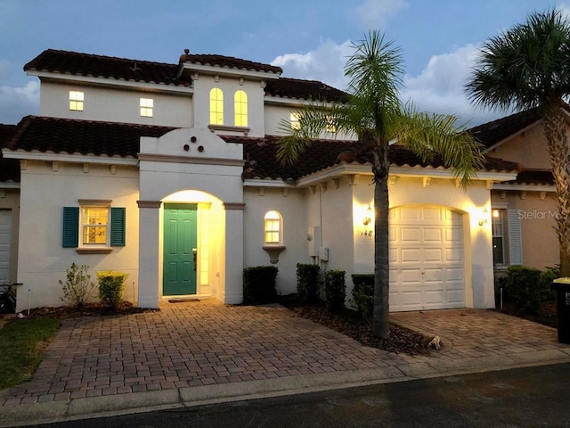 mediterranean / spanish-style home featuring a garage