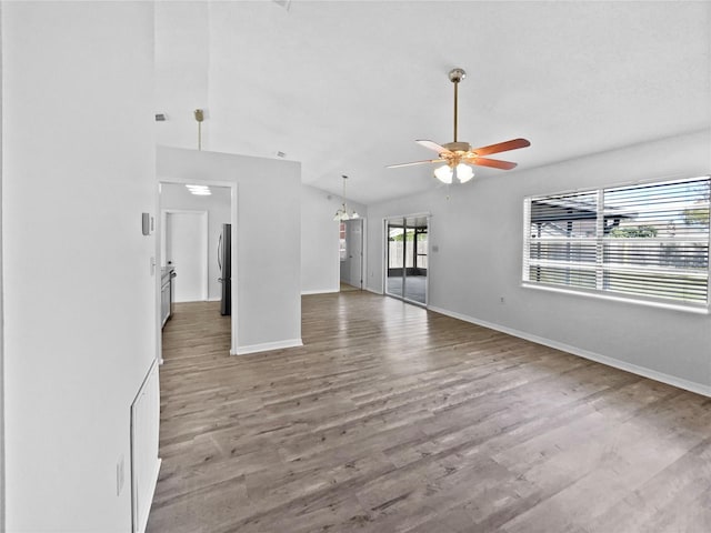 unfurnished living room with wood-type flooring, ceiling fan, and lofted ceiling