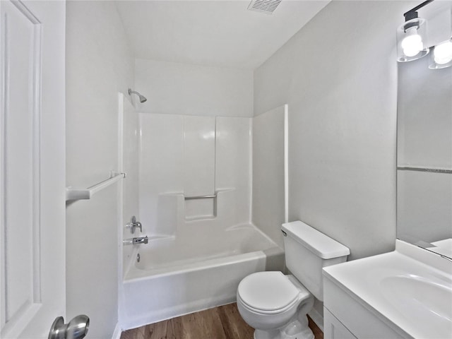 full bathroom featuring hardwood / wood-style flooring, vanity, toilet, and shower / tub combination