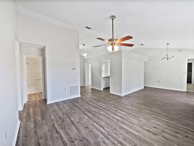 unfurnished living room featuring ceiling fan with notable chandelier, vaulted ceiling, and hardwood / wood-style flooring