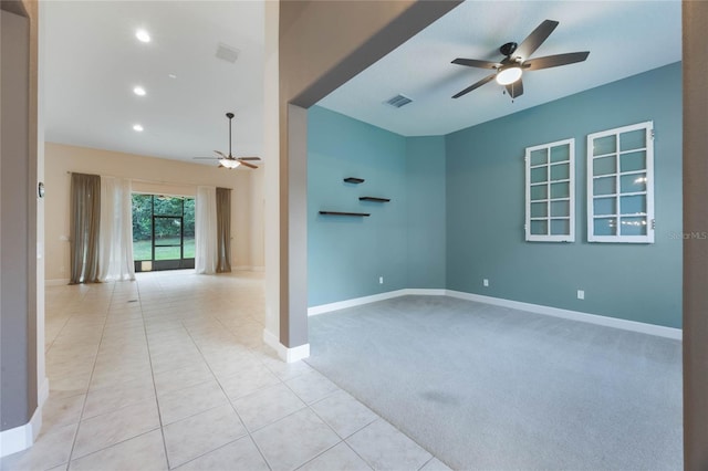 spare room featuring light carpet and ceiling fan