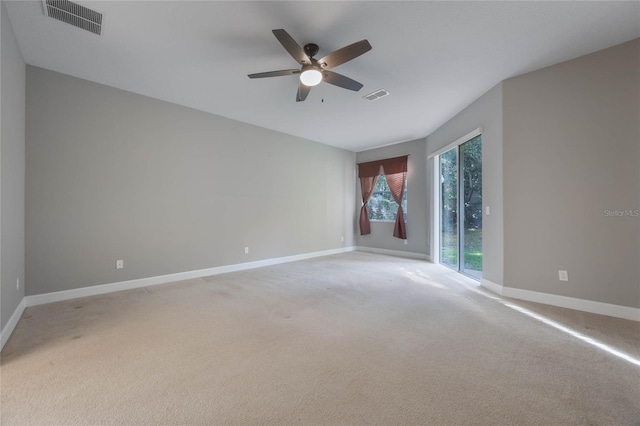 empty room featuring ceiling fan and light colored carpet