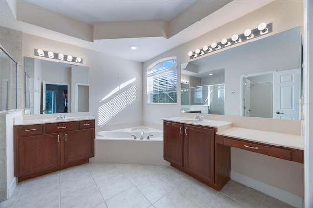 bathroom featuring tile patterned floors, vanity, and shower with separate bathtub