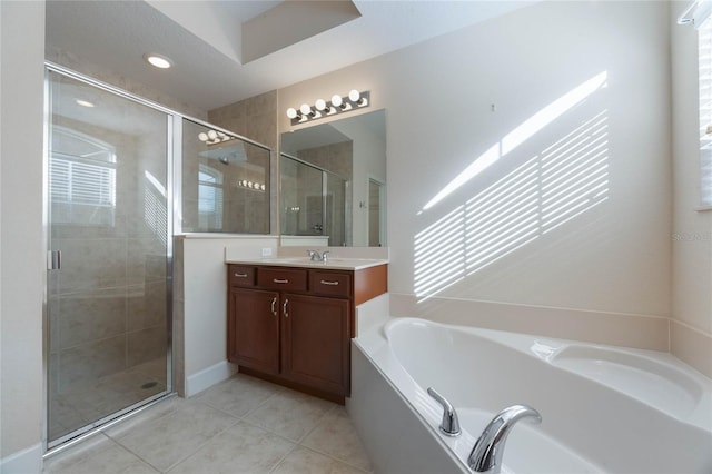 bathroom featuring plus walk in shower, tile patterned flooring, and vanity