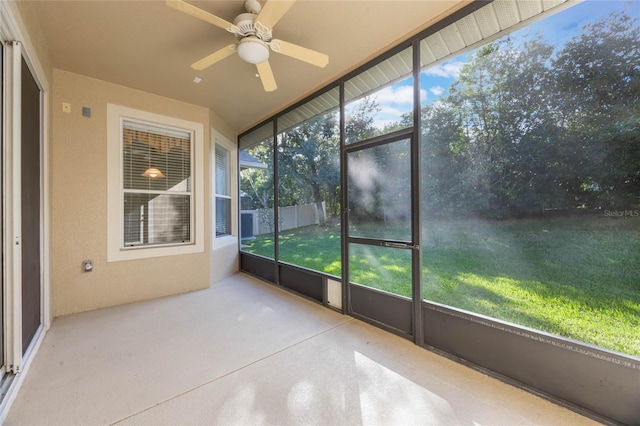 unfurnished sunroom featuring ceiling fan