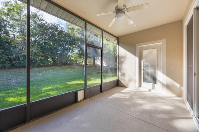 unfurnished sunroom with ceiling fan