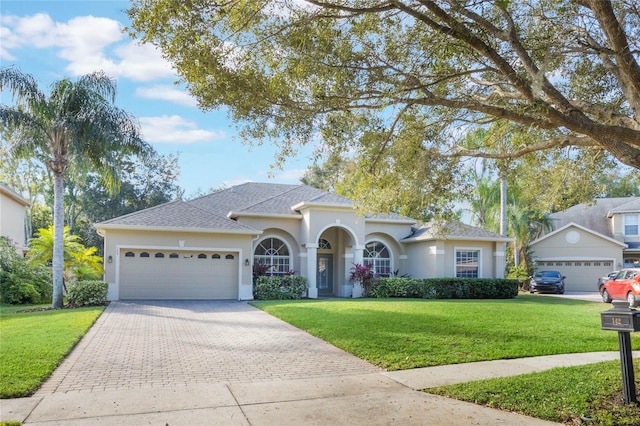 view of front facade featuring a front lawn and a garage