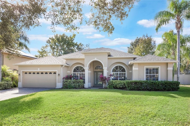 view of front of home with a garage and a front lawn