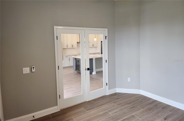 empty room with wood finish floors and baseboards