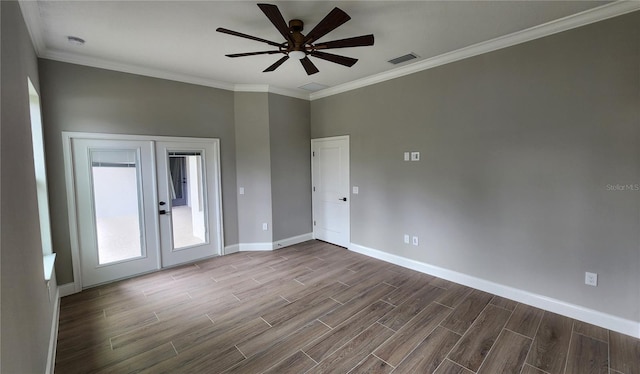 spare room with wood tiled floor, baseboards, crown molding, and french doors