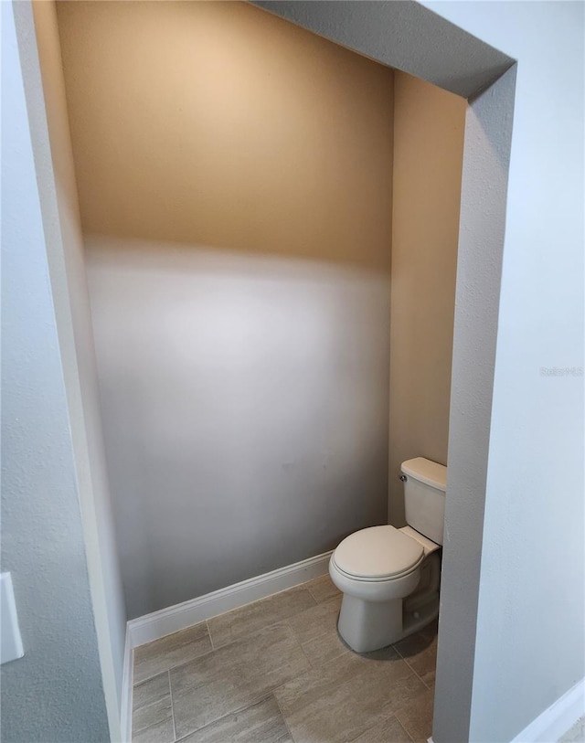 bathroom featuring toilet and baseboards