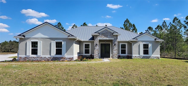 craftsman-style home with metal roof, a front lawn, and stucco siding