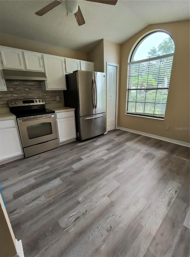 kitchen with ceiling fan, stainless steel appliances, tasteful backsplash, light hardwood / wood-style floors, and white cabinets