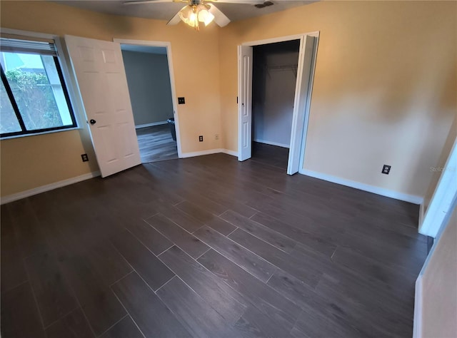 spare room featuring ceiling fan and dark wood-type flooring