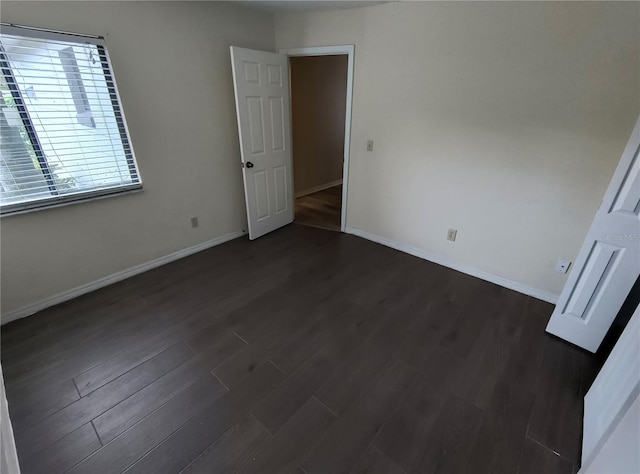 unfurnished bedroom featuring dark hardwood / wood-style floors