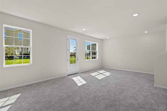 carpeted spare room with a wealth of natural light